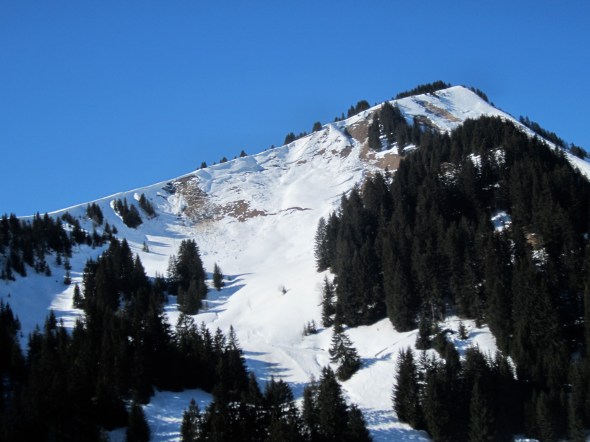 Abondance - Snow slipping off the faces onto bare rock and grass. 