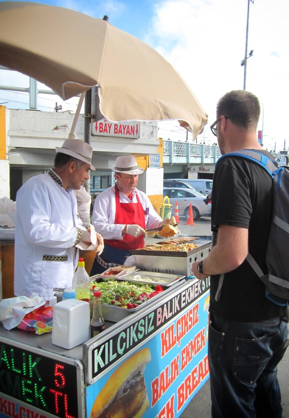 Our happy men selling tasty fish sandwiches